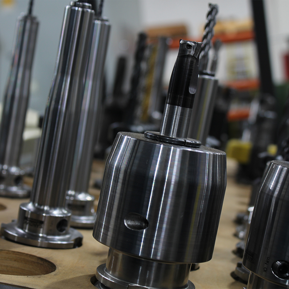 CNC tool holders and end mills staged at FM Machine