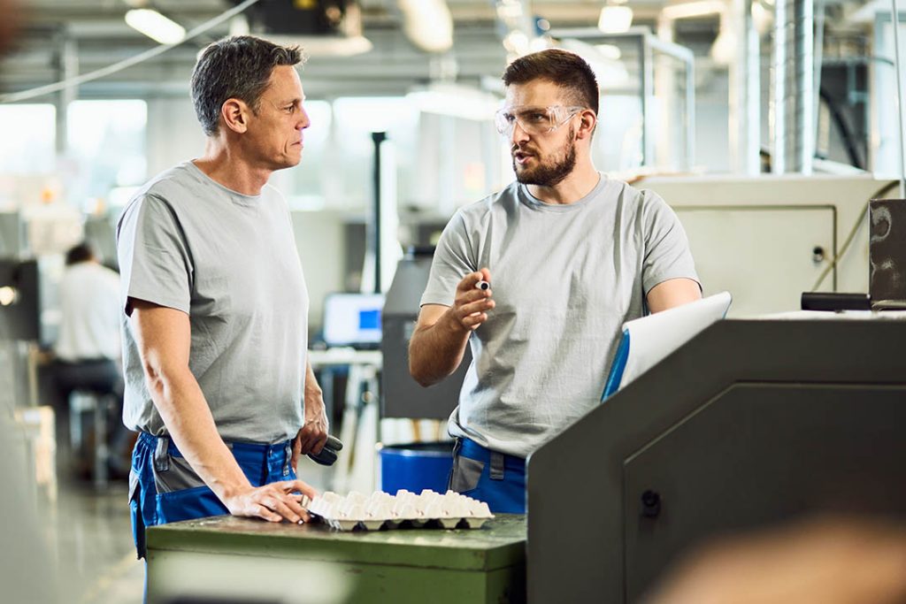Industries Served - coworkers communicating while working in precision machining