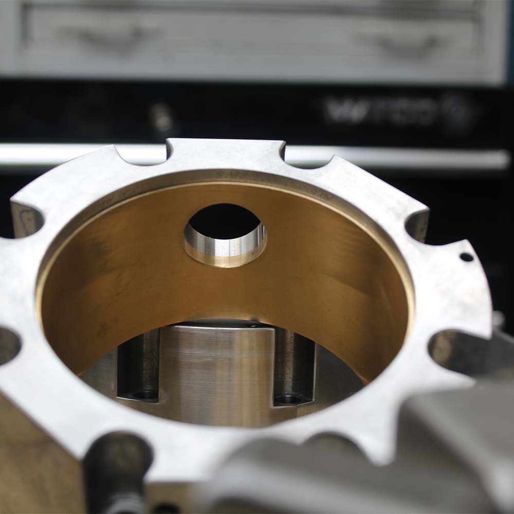 Precision machined housing with bronze-lined bore by FM Machine
