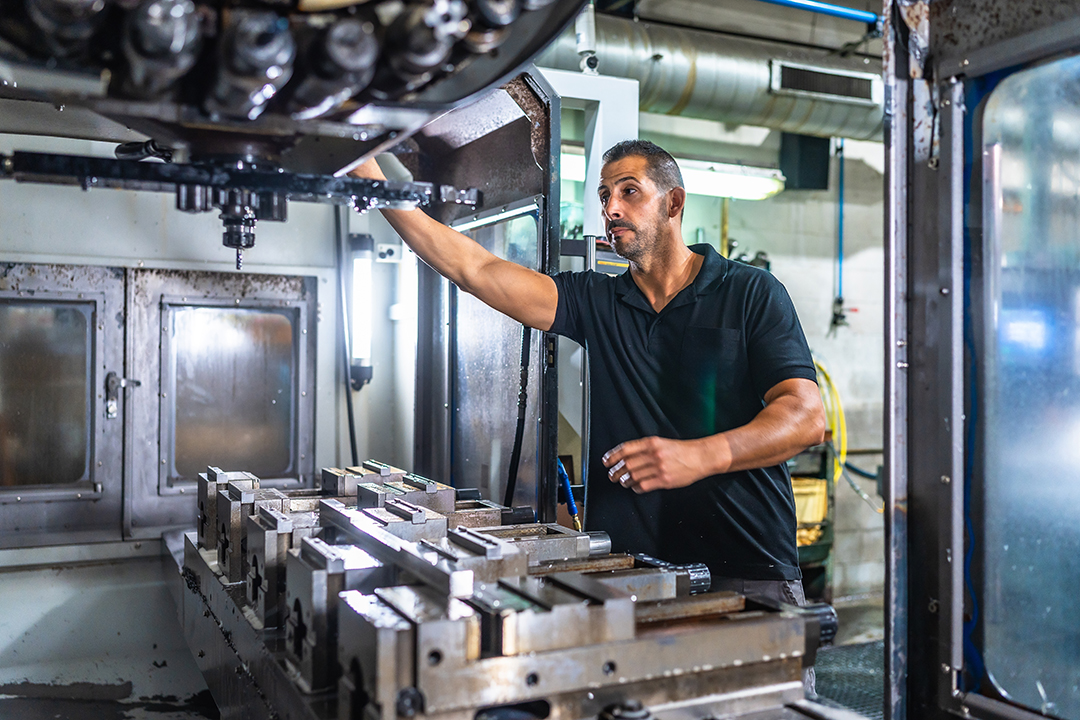 technician working with milling machine in a cnc